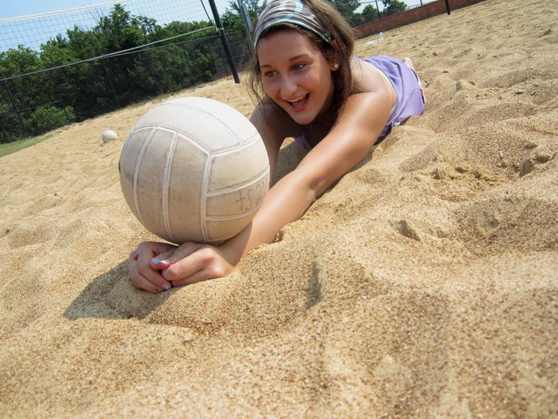 Diving to not let the ball touch the ground, junior Rachel Ellis lies flat in the sand. The whole volleyball program met at Manchester Park at 9 a.m. to play sand volleyball and tie-dye t-shirts on Aug. 17. “It wasn’t your normal volleyball atmosphere, so being able to play outside with the whole team inspired us to be creative with the activities we did,” Ellis said. 