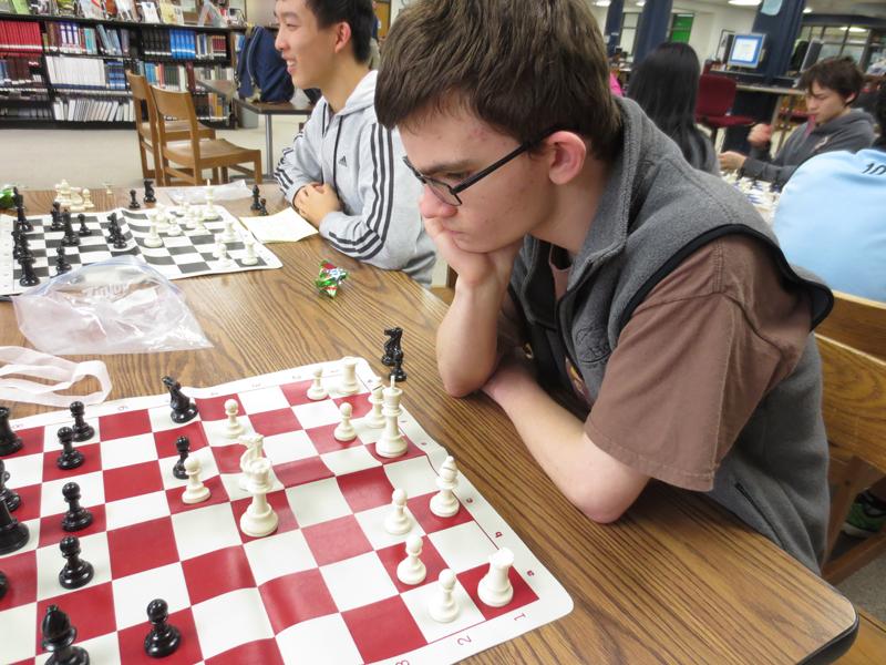 While planning his next move, senior David Mcknight, Chess Club Co-President, watches the board. Chess Club meets after school every Tuesday in the library. I love the Chess Club because anyone can come and play and I like helping others learn about the game. I just really like being with my peers enjoying a great game, McKnight said. 