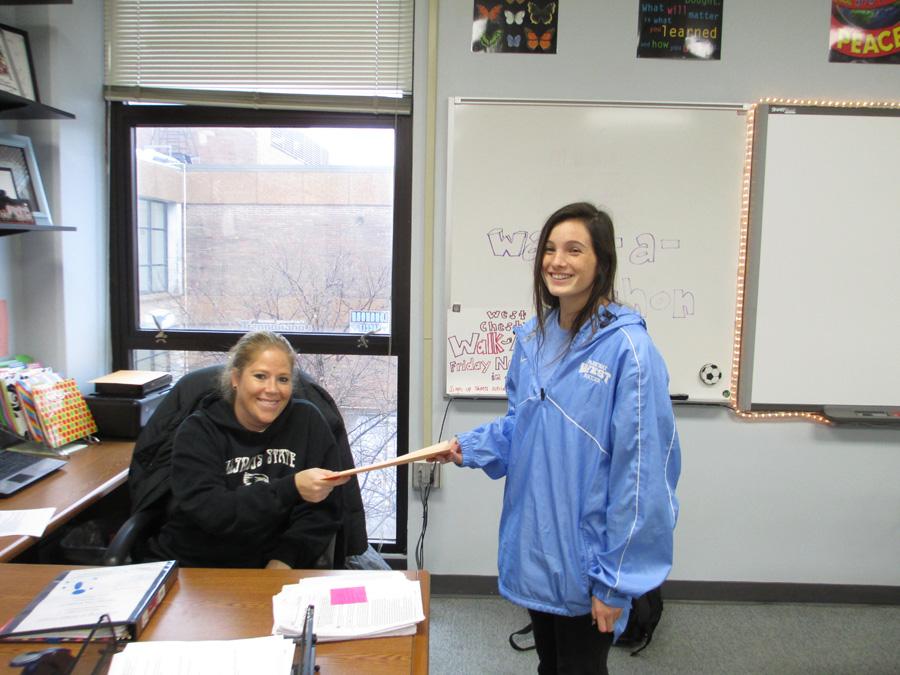 Sophomore Lily Briscoe hands in her money she earned for the Walk-a-Thon to teacher sponsor Annie Wayland. The Walk-a-Thon ends West Chest Week, a week of efforts to raise money for local charity West Chest. “The charity West Chest comes right back to our own West community and helps those families in need. There are far more families that need this help than most students recognize,” West Chest sponsor Susan Anderson said.