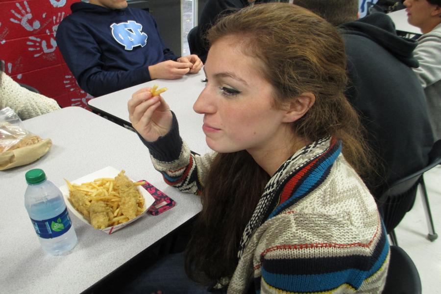 Senior Megan Reilly eats her school lunch of chicken fingers and french fries.
I buy my lunch everyday, and it looks more appetizing. It no longer looks fake, she said.