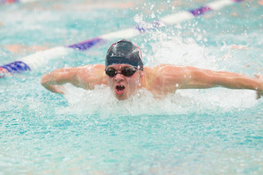 Senior David Peck in the middle of a butterfly stroke during a meet.