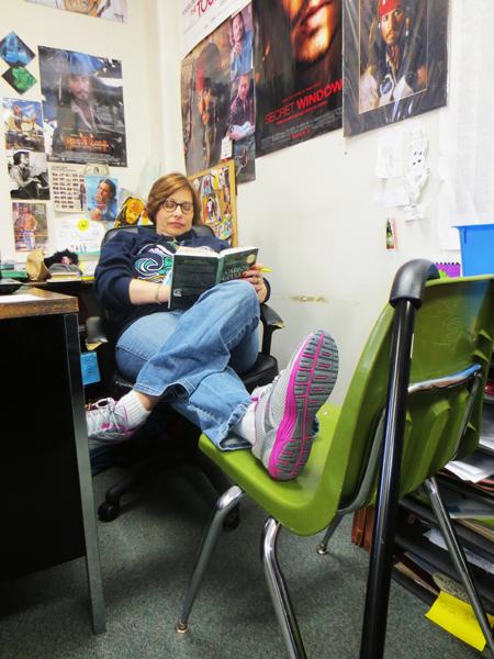 Creative Writing teacher Carolyn Dixon reads during class silent reading time.  Dixon kept her foot elevated daily and used a cane to get through the halls.