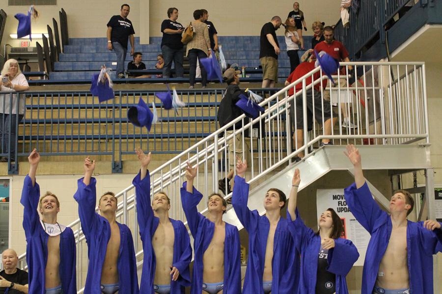 Seniors Ryan Schlueter, Grant Keesling, Chandler Klemm, Nicholas Klemm, Joshua Emde Hillie Hedgecock and Eli Harris throw their caps at their graduation ceremony at the St. Peters Rec Plex after the state championship game.