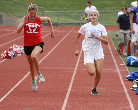 Senior Maddy Brown and sophomore Natalie Rath sprint toward the finish of the 2.2 mile race at Red & Blue night on Aug. 15.