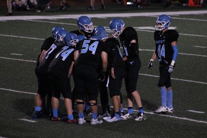 The Longhorns offense huddles up Friday night against Union. The offense scored 49 points led by running backs Nick Lewis and Simon Lindo who totaled 378 yards rushing. 