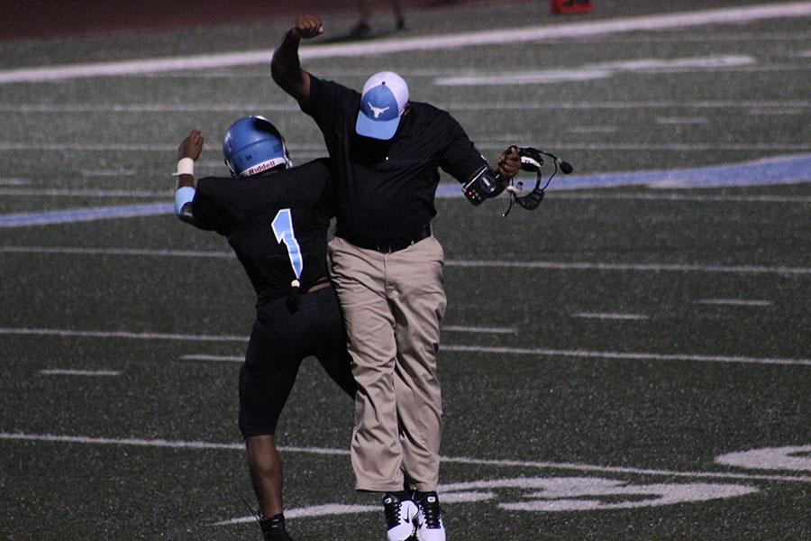 Junior running back Nick Lewis celebrates with assistant coach Melvin Bethany after a touchdown. 