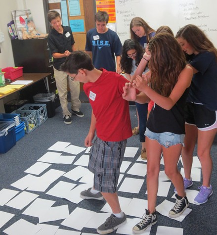 Freshman Graham Chambers-Wall participates in group number 62's eight-by-eight paper game.  Group 62's theme was Dr. Suess.  Group leaders juniors Molly Sewester and Mahnoor Malik spent $50 creating costumes.