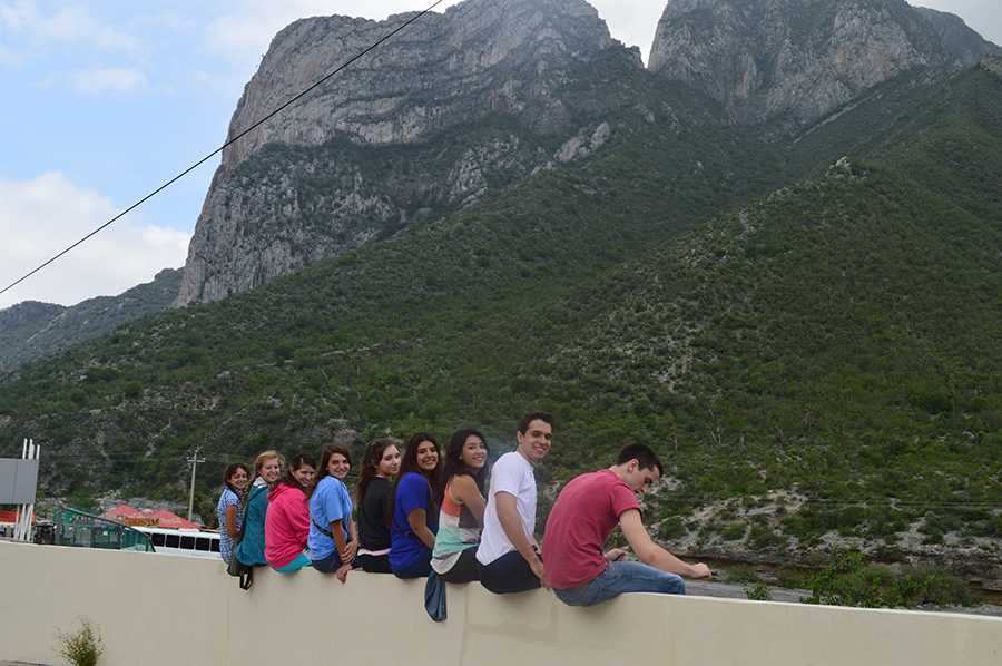 Junior Lauren Schumacher, Prepa Tec student Jessica Vellejo, junior Ellie Nazzoli, Prepa Tec students Karen, Jessica, Alicia, and Gonzalo, senior Nathan Rands and Bayleigh Williams sit on a wall facing Monterreys mountains. We were waiting to go into the famous Caverns of Garcia. Even though it was too dark to go into the caverns, we still made the most of our trip there, Williams said.