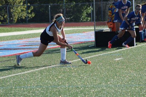 Junior Emma Ratliff inserts the ball for a planned corner Sept. 8 against Clayton as her team sprints into the circle.