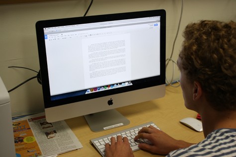 Junior Noah Andrews  uses Google Drive for a short story essay in Erin Fluchels English III class.