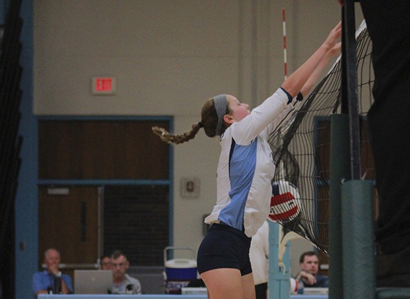 Defending the net, freshman Colleen Smith blocks her opponents spike in a game against Lindbergh.