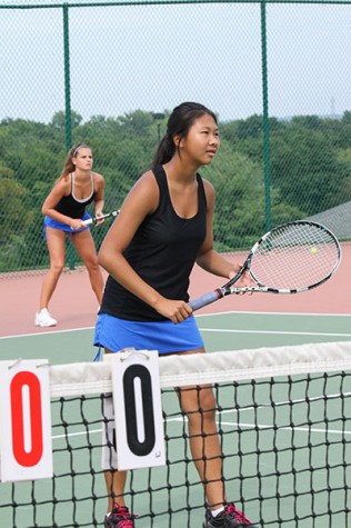 Freshman Sydnee Yap and Senior Stephanie Quoss setting up for a doubles match vs Lafayette High School.