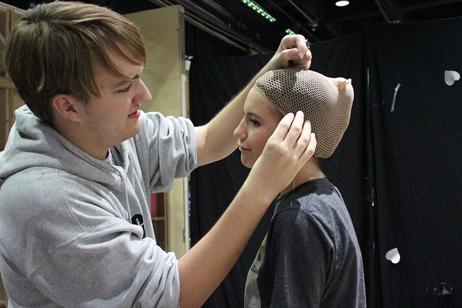 “I am one of the company stage managers. I make sure the costumes are all in place and I assist the actors in changes,” junior Tristan Johnson said. “I have to pin a lot of wig caps and make sure they don’t fall off too. It’s pretty stressful running back and forth backstage trying to get things in place, and tensions get pretty high when things aren’t done correctly.”