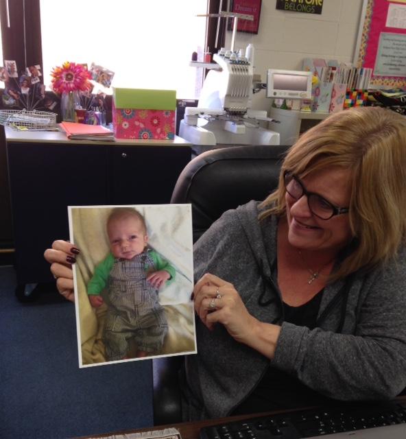 FACS teacher, Renee Broemmelsick looks at a picture of her new grandson. 