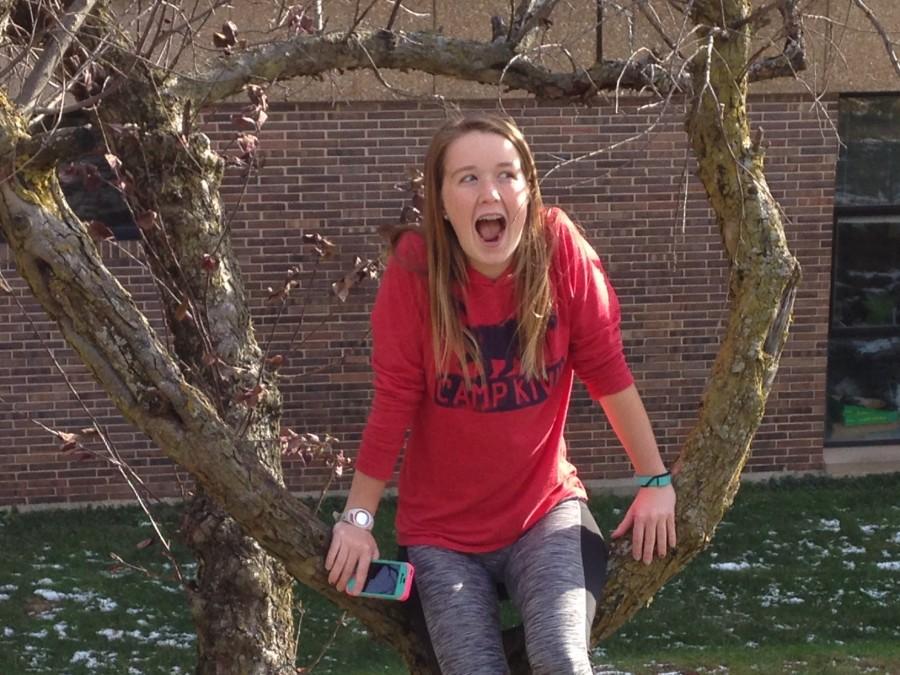 Freshman Jane Fuller goofs around in a tree despite the cold weather. 