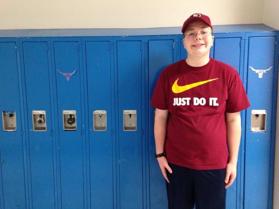 Junior Holt Priest stands along the science hallway lockers. 