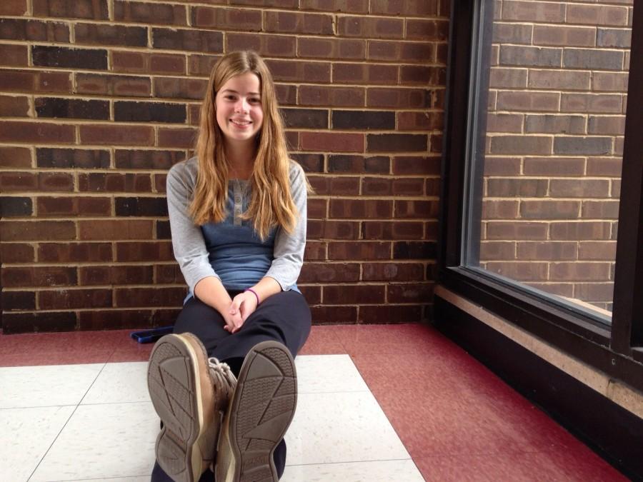 Eager for the weekend to start, junior Julie Whitten sits by a window. 