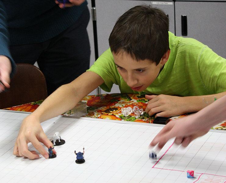 Freshman Jack Burraston in the middle of a move in a session of Dungeons and Dragons. I like it because I enjoy spending time with the people there, because the people are fun to be around, Burraston said.