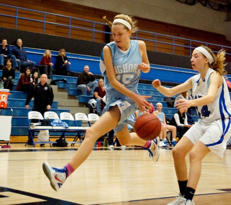 Diving to save the ball from going out of bounds, sophomore Grace Folkins hits the ball back in play