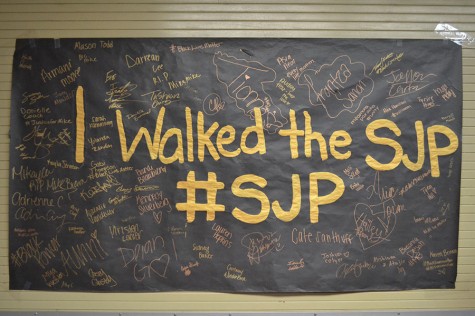 Students signed a poster after a silent protest to show their support for social justice.