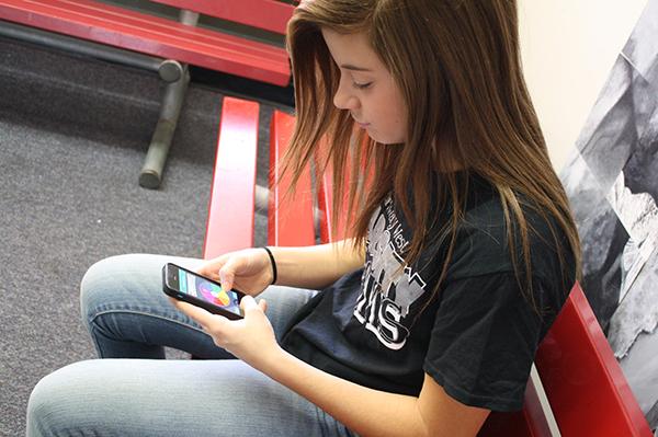 Student Kennedy Silverberg takes a break from studying  to play Trivia crack . 