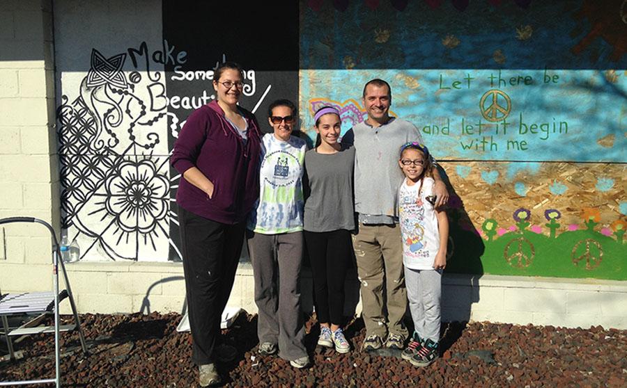 Chistina Neuwirth, Laura Neuwirth, Kayln Neuwirth-Deutsch, Blaine Deutsch and Julia Neuwirth-Deutsch spend a day in Ferguson brightening up the community as they painted four boarded up windows over Thanksgiving break. 