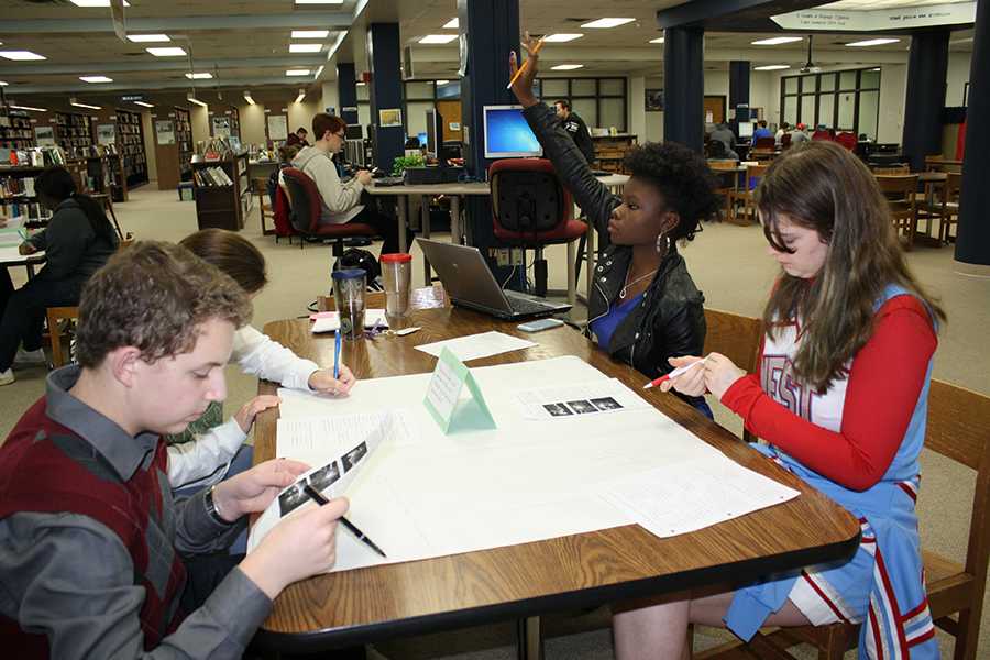 During Lauren Bernsteins Spanish III class, sophomores Grant Cline,  Alyssa Jackson and Victoria Marston participate in a silent written debate about the Michael Brown case. Its ironic this is falling on the same day as the scheduled walk-out; that was not intentional, Bernstein said.