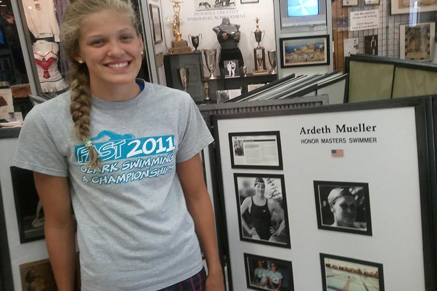 Sophomore Evie Pfeiffer stands by her grandmother, Ardeth Muellers, exhibit at the International Swimming Hall of Fame in Fort Lauderdale, Fl.  Pfeiffers grandmother went to the 1956 Olympic Trials in Detroit for the 100m fly, placing eighth in the nation. It feels great to be a third generation swimmer, I love that there are so many years of swimming [in my family] that I can be compared to, and I cant wait to further our legacy, Pfeiffer said. 