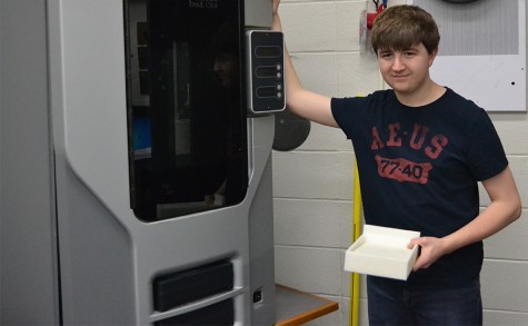 Matt Sauer stands beside his 3D printer