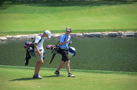 Senior Brian Ingberg walks to the next hole at Forest Hills Country Club for the varsity district tournament.