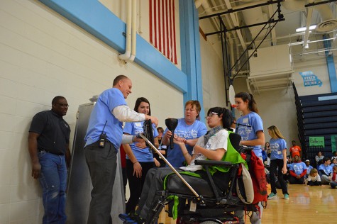 Principal Jeremy Mitchell and senior Jacob Dennison light the opening ceremony torch.