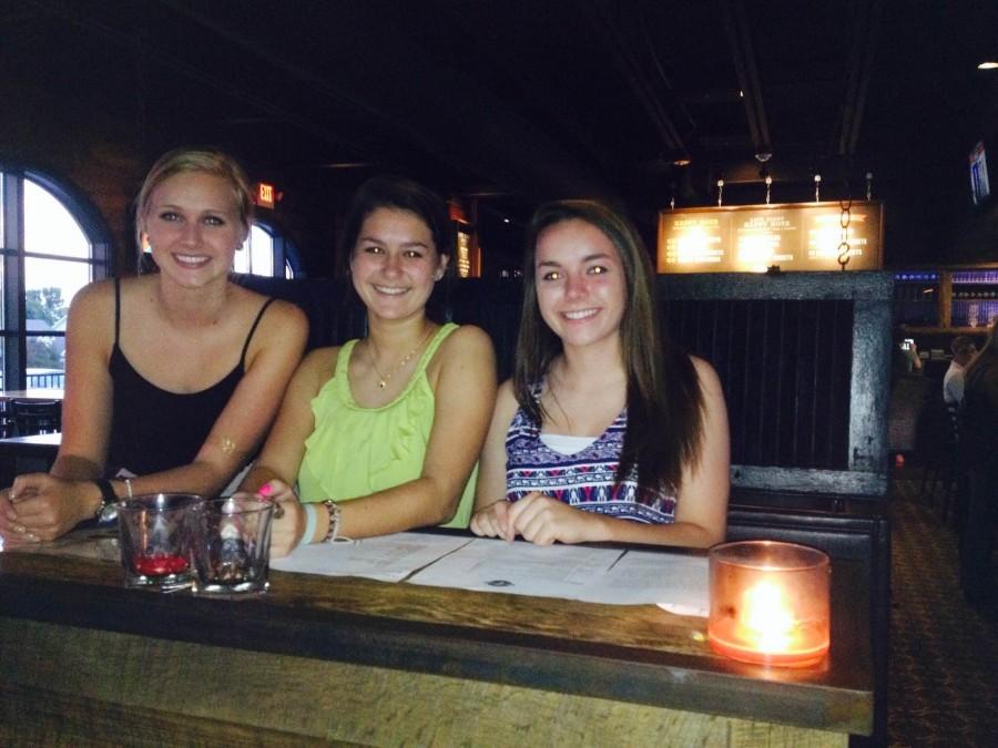 At the two year anniversary party of Circle 7 Ranch, Marquette senior Caroline Harms, sophomores Demi Ferretti and Alyssa Fleming greet and seat customers.