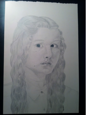 Freshmen Sophia Malpocker's self portrait hung in West High's art show. 