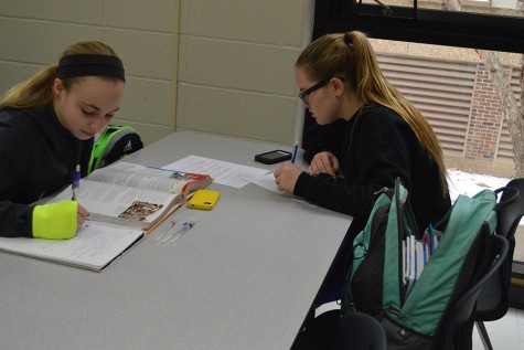 Freshman Alyssa Obermyer and Caitlin Brandenburg work diligently on their homework during study hall.