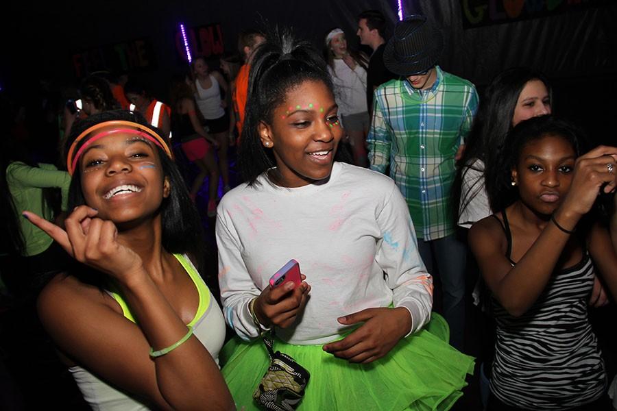 Alumni Nicole Simmons, Lisa Savage and Casey Glasby dance at the 2015 Glow Dance. The Glow Dance was held Feb. 27 in the gym. “It was amazing. I had the best day of my life there. Everyone was all happy and dancing and partying; it was a great day,” Simmons said. 