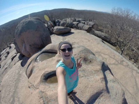 Climbing over boulders, junior Tabatha Saake visits Elephant Rocks State Park in Belleview, MO.