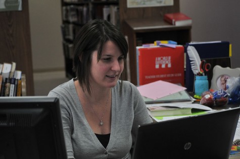 Librarian Lauren Reusch does her work in the library. She has been working on staff since Oct. 27. “Mrs. Reusch is very good with our new circulation program; she used it prior to our using it since our school now has it. She’s very good at finding books and working with kids, and she has a great rapport with all the students,” library assistant Deb Geiser said.  