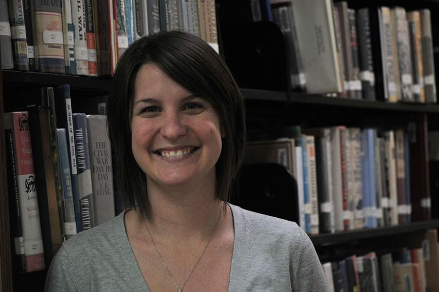 Librarian Lauren Reusch poses in the library. 
