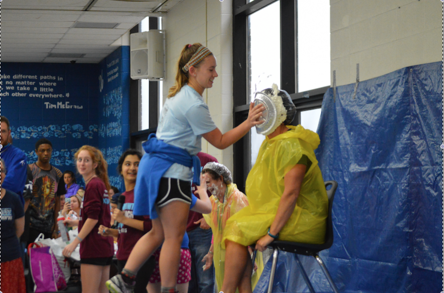 Junior Emily Wind pies Kristen Collins for Cash for Cancer. 