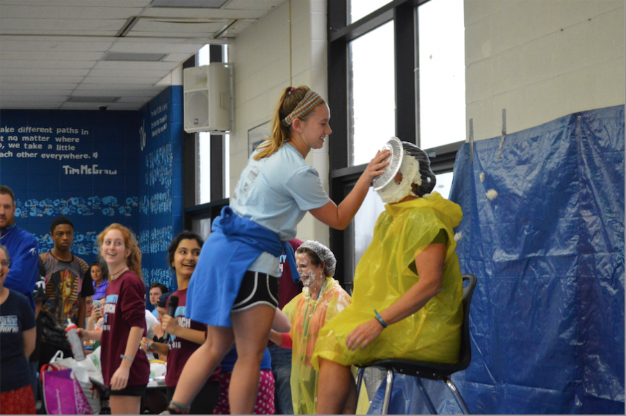 Junior Emily Wind pies Kristen Collins in the face for Cash for Cancer. 