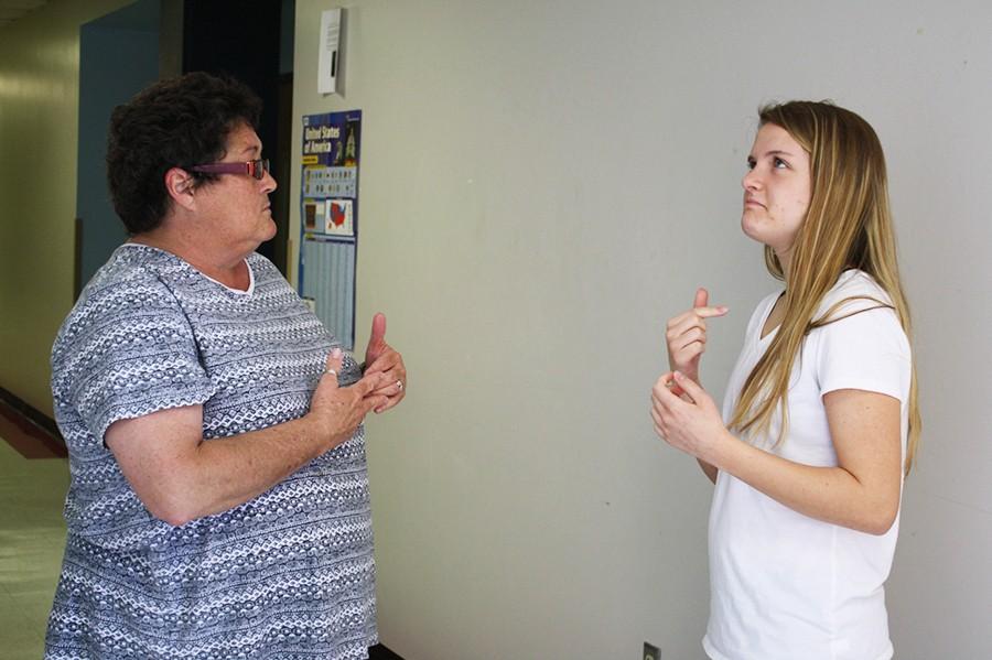 Junior Rachel Ebner signs with her interpreter, Kathy LaBoo before history class.