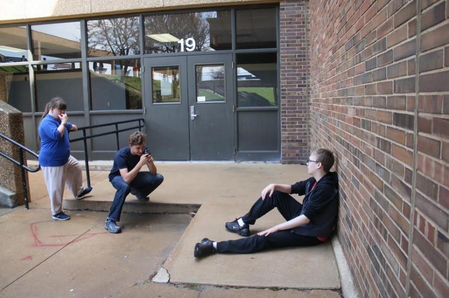 Senior Lindsey Hacker, freshman Alex Volz and freshman Jack Vaughan shoot two films with different styles in front of the school. The first film featured Vaughan as a crazy man visiting a shrink. “The second one was a musical about Jack, as the original crazy man, roaming the streets thinking he’s completely sane,” Volz said.