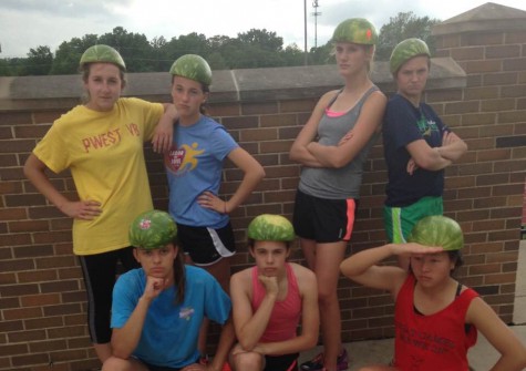 Girls Track poses for a picture after the run with the watermelon rind on their heads.