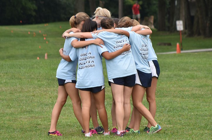 The varsity racers gather before their race to discuss strategies. “I know we’ve swept the last two, but there may have been more. I do know that out the nine years we’ve done this, our varsity team has won seven times. The only two times we didn’t win, we were beaten by our rival, Central,” head coach Charlie Cutelli said.