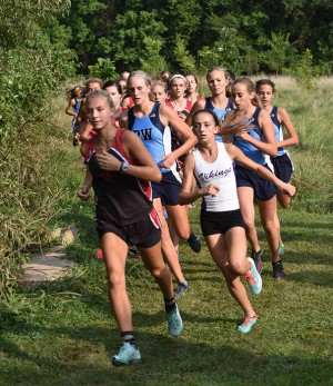 The front pack, senior Rachel Osbourne, freshman Natalie Butler, freshman Claire Smout and junior Maggie Morse track down the leading racers in the varsity race. “While I was running I was trying to figure out the Central girl’s strategy so I got thrown off at the end because I couldn’t decide if I should go hard in the middle or not,” Osbourne said.