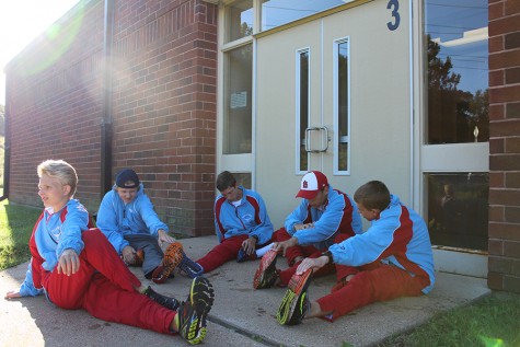 The varsity team completes static stretches in the shade by an enterance to Northwests campus. Placing third in their competition, the team had four of their top five  place in the top 20, adding up to a team score of 66.