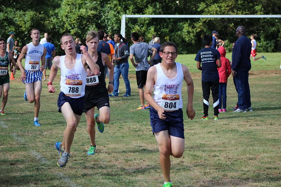 Senior Derek DiStefano and sophomore Nathan Stucki stride to the finish line of the 5k course in the last .1 miles of their race.  Dropping seven minutes from his time at the course the previous year, Stucki ran his race in a time of 20:37.