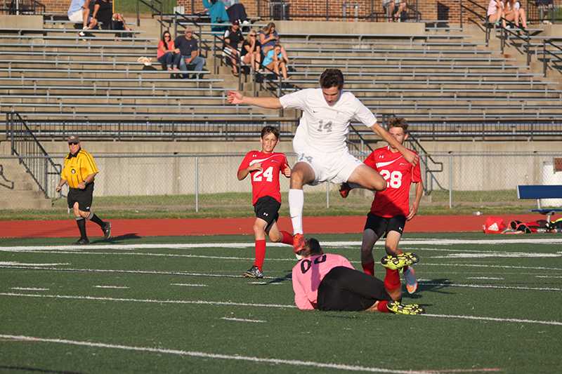 Attempting to beat the goalie to the ball, senior Wyatt Harlan jumped over West Plains goalie to avoid injury. The game ended in a 10-1 victory for the Horns.