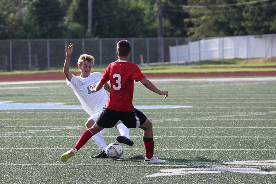 Senior Jack Stiegemeyer steals the ball from an opponent at the soccer game on August 21 versus West Plains. West Plains is a high school four hours away near the Missouri-Arkansas border. “I felt bad, the team drove a long way to get stomped on,” Stiegemeyer said. 