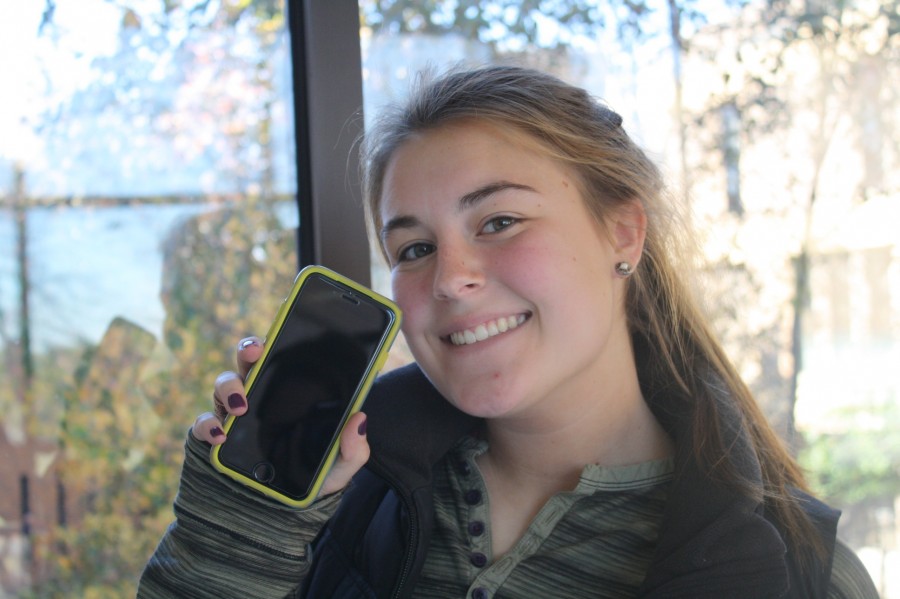 Maddie Rose holds up her new iPhone 6S.